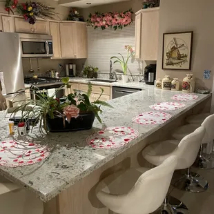 a kitchen with a center island and bar stools