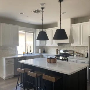 a large kitchen with a center island