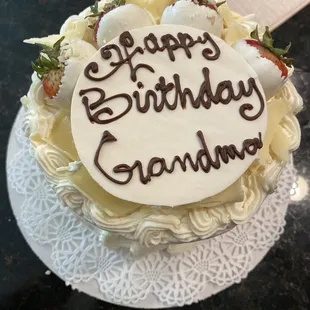 white chocolate sign that reads &quot;happy birthday grandma&quot; beautifully decorated