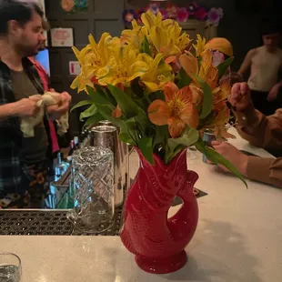 a vase of flowers on a counter