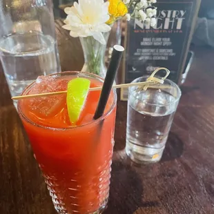 a bloody drink with a garnish of lime