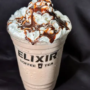 a milkshake topped with whipped cream and caramel