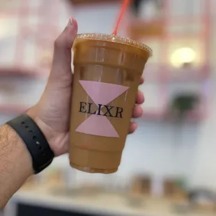 a hand holding a cup of coffee