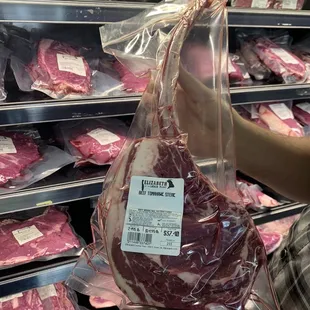 a person holding a piece of meat