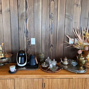 a coffee maker and other items on a wooden table