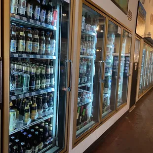 a row of beer bottles in a cooler