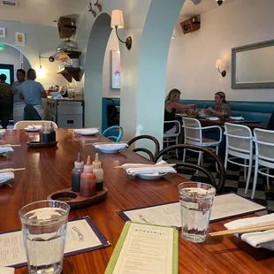 the dining room with people sitting at tables