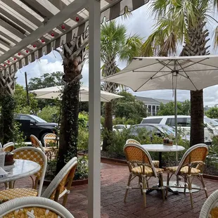 tables and chairs under an umbrella