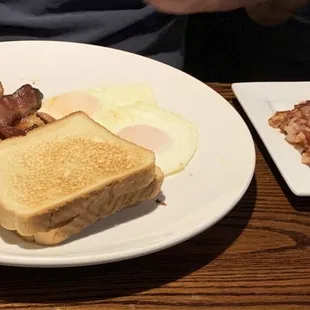 Two eggs over easy, bacon, toast and a side of corned beef hash.