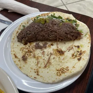 Barbacoa taco with onion and cilantro