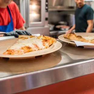 two slices of pizza on plates