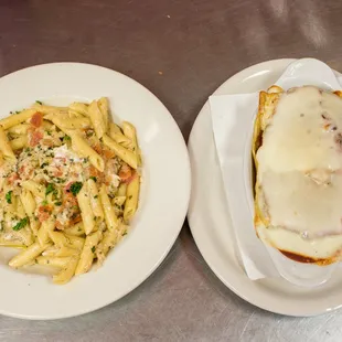 two plates of pasta and a sandwich