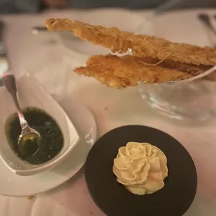 Crispy cracker/bread with pesto and whipped vegan butter