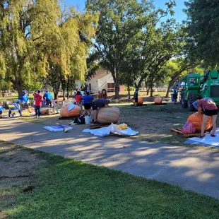 Contestants carving their pumpkin boats for the regatta