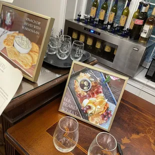 a menu, wine glasses, and wine bottles