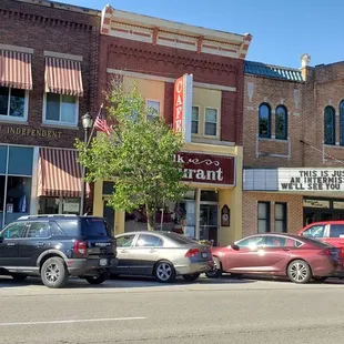 a row of cars parked on the side of the road
