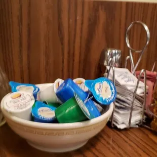 a bowl of toothpaste, toothbrushes, and other condiments