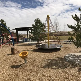 Merry go round with climbing net. Little yellow spinning seat.
