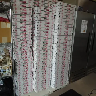 Mountain of boxes waiting to fly out the door with hot pizzas!