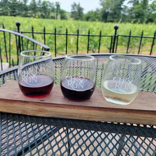 three glasses of wine on a cutting board