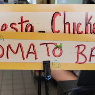 a sign that says fiesta chicken and tomato basil