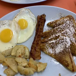 French toast breakfast w/ 2 eggs sunny side up, bacon, and home fries. $10.99