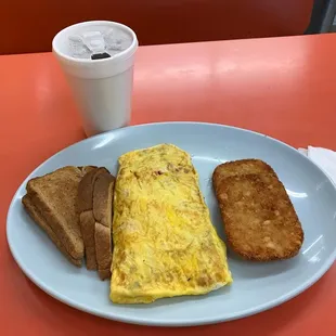 Western omelette with wheat toast, hash browns, and hot green tea.