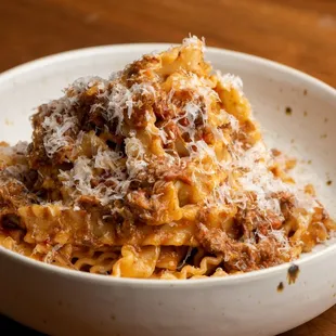 a bowl of pasta with meat and cheese