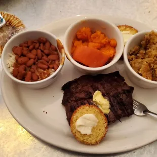 a plate of food with beans, carrots, and bread