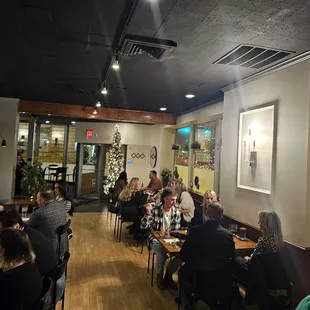 people sitting at tables in a restaurant