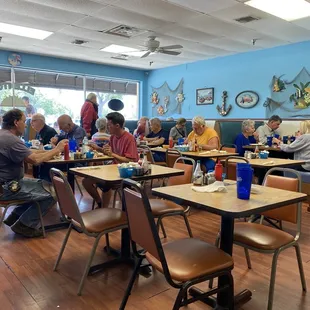 people sitting at tables eating