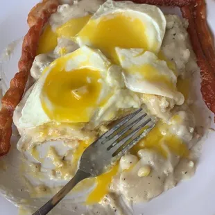 Two eggs over easy with bacon and sausage gravy over biscuits, sorry but I put my eggs on top of the main course