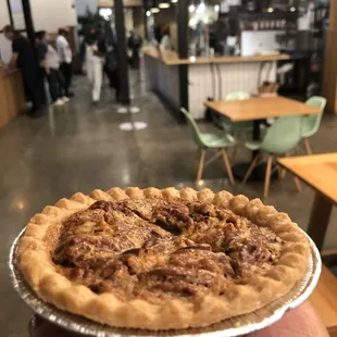 a hand holding a pie