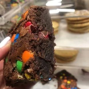 a hand holding a chocolate cookie