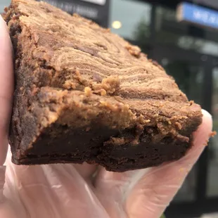 a hand holding a brownie