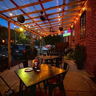a patio with tables and chairs