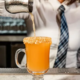 a bartender pouring a drink