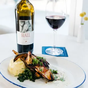 a plate of food and a glass of wine