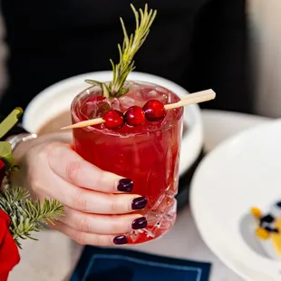 a person holding a cocktail