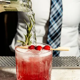 a bartender pouring a drink