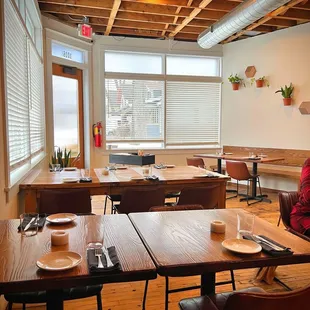 a woman sitting at a table in a restaurant