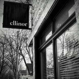 a black and white photo of a storefront