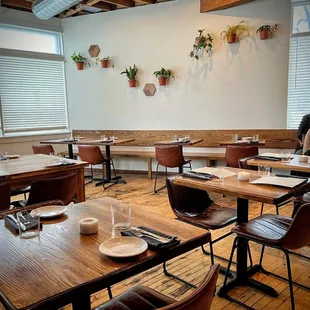 a woman sitting at a table in a restaurant