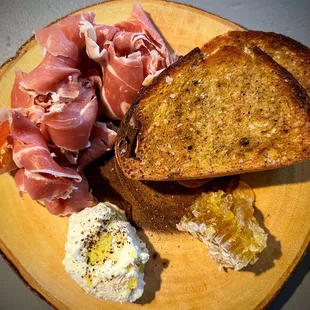 a plate with bread, eggs, and ham