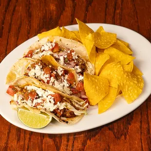 Gilled Salmon Tacos: Grilled cracked wheat sourdough with mixed greens, sliced tomato, red onion, cucumbers, avocado, and grilled salmon.