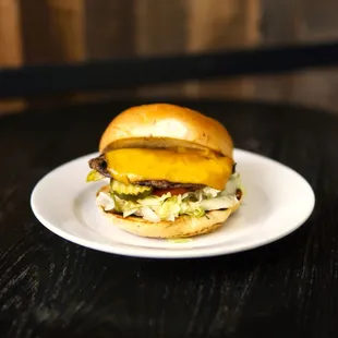 Cheapsburger: Same great burger, just a bit smaller. Cheddar cheese, lettuce, tomato, onion, pickle, and pub sauce on a spent grain bun.