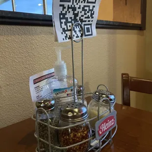 Table seasonings, drink menu QR code, and hand sanitizer (appreciated!)