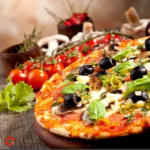 a pizza with olives, mushrooms, and herbs