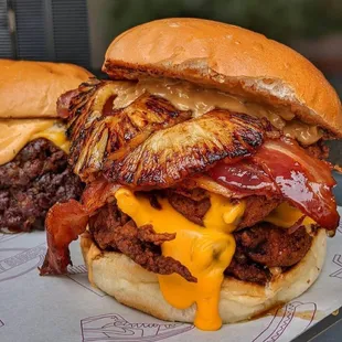 two burgers with bacon and cheese