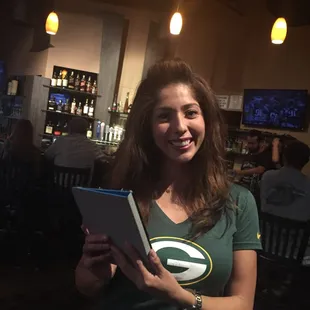 a smiling woman holding a book